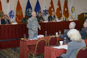 Maj. Gen. Nick Justice, USA, Research, Development and Engineering Command, stands to welcome the panel at the January event, which included (l-r) Capt. Kent Gritton, USN (Ret.), Joint Training Integration and Evaluation Center; Richard Cozby, Assistant Secretary of the Army for Acquisition, Logistics and Technology; Col. Marcus Boyd, USAF, Air Force Agency for Modeling and Simulation; and Maj. Gen. Bob Williams, USA, Raytheon Company.